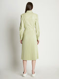 Back full length image of model wearing Faux Leather Pleated Skirt in GREEN TEA