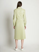 Back full length image of model wearing Faux Leather Pleated Skirt in GREEN TEA