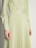 Detail image of model wearing Faux Leather Pleated Skirt in GREEN TEA