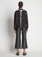 Back full length image of model wearing Tie Dye Sweatshirt in BLACK/OFF WHITE