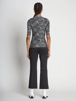 Back full length image of model wearing Speckle Knit Sweater in PEARL/BLACK