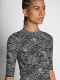 Detail image of model wearing Speckle Knit Sweater in PEARL/BLACK