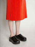 Detail image of model wearing Faux Leather Pleated Skirt in VERMILLION
