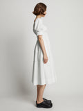 Side full length image of model wearing Square Neck Poplin Dress in OFF WHITE