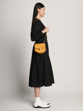 Side image of model carrying Mini Round Dia in CARAMEL