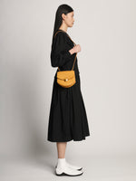 Side image of model carrying Mini Round Dia in CARAMEL