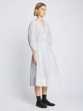 Side full length image of model wearing Poplin V-Neck Dress in WHITE