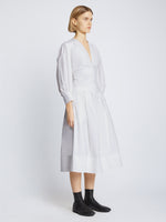 Side full length image of model wearing Poplin V-Neck Dress in WHITE