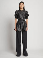 Front full length image of model wearing Leather Belted Top in BLACK