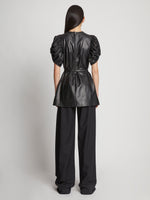 Back full length image of model wearing Leather Belted Top in BLACK