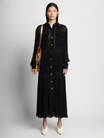 Front full length image of model wearing Sheer Pleated Flou Dress in BLACK