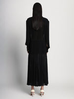 Back full length image of model wearing Sheer Pleated Flou Dress in BLACK