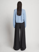 Back full length image of model wearing Eco Cashmere Cardigan in LIGHT BLUE