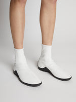 Image of model wearing Grip Stretch Ankle Boots in White