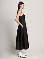 Side full length image of model wearing Poplin Bustier Dress in BLACK