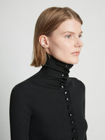 Detail image of model wearing Eco Superfine Merino Button Down Sweater in BLACK