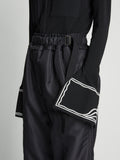 Detail image of model wearing Silk Nylon Taffeta Pants in BLACK