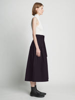 Side full length image of model wearing Poplin Belted Skirt in BLACK