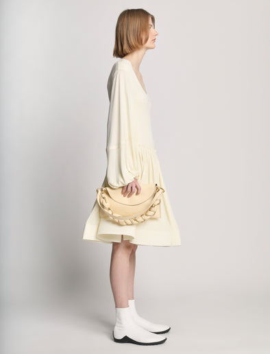 Side image of model carrying Braid Bag in BIRCH