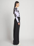 Side full length image of model wearing Printed Floral T-Shirt in PURPLE MULTI