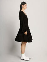 Side full length image of model wearing Viscose Crepe Jersey Dress in BLACK