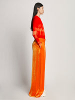 Side image of model wearing Viscose Knit Tie Dye Top in orange multi