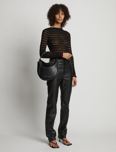 Image of model carrying Medium Baxter Leather Bag in BLACK