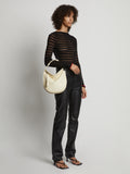Image of model carrying Medium Baxter Leather Bag in IVORY