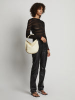 Image of model carrying Medium Baxter Leather Bag in IVORY