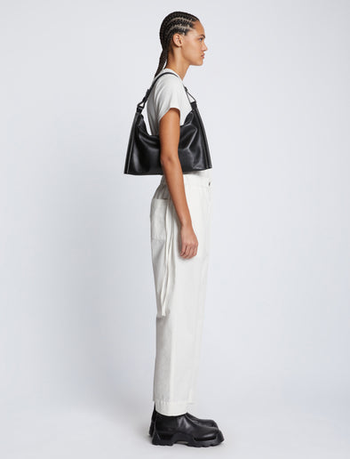 Image of model carrying Minetta Bag in BLACK on shoulder