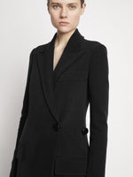 Proenza Schouler detail image of model wearing Bi-Stretch Crepe Wrap Coat in black