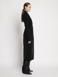 Proenza Schouler side image of model wearing Bi-Stretch Crepe Wrap Coat in black