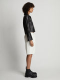 Side image of model wearing Faux Leather Shorts in off white
