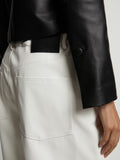 Detail image of model wearing Faux Leather Shorts in off white