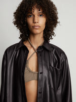 Detail image of model wearing Faux Leather Shirt Jacket in black