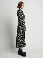 Side image of model wearing Printed Long Sleeve Shirt Dress in mint/black