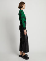 Side image of model wearing Knit Floral Cardigan in green/black