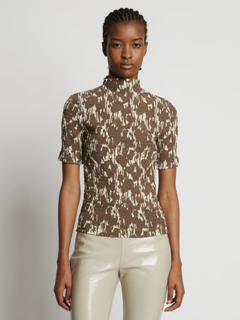 Cropped front image of model wearing Viscose Flou Smocked Top in buttercream/fawn