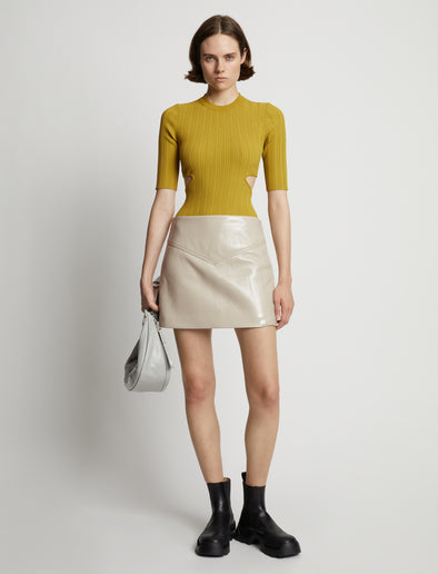 Front image of model wearing Vinyl Mini Skirt in fawn