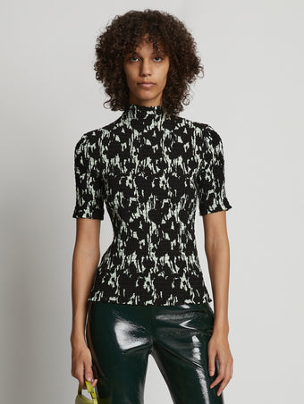 Cropped front image of model wearing Viscose Flou Smocked Top in mint/black