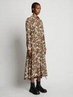Side image of model wearing Printed Long Sleeve Shirt Dress in buttercream/coffee