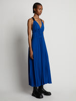 Side image of model wearing Broomstick Pleated Tank Dress in cerulean