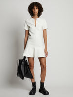 Front image of model wearing Faux Leather Ruffle Mini Dress in off white