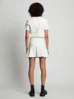 Back image of model wearing Faux Leather Ruffle Mini Dress in off white