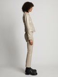 Side image of model wearing Vinyl Cropped Jacket in fawn