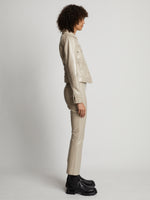 Side image of model wearing Vinyl Cropped Jacket in fawn