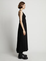 Side image of model wearing Broomstick Pleated Tank Dress in black