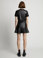 Back image of model wearing Faux Leather Ruffle Mini Dress in black