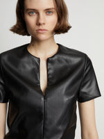 Detail image of model wearing Faux Leather Ruffle Mini Dress in black