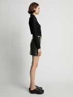 Side image of model wearing Vinyl Mini Skirt in pine